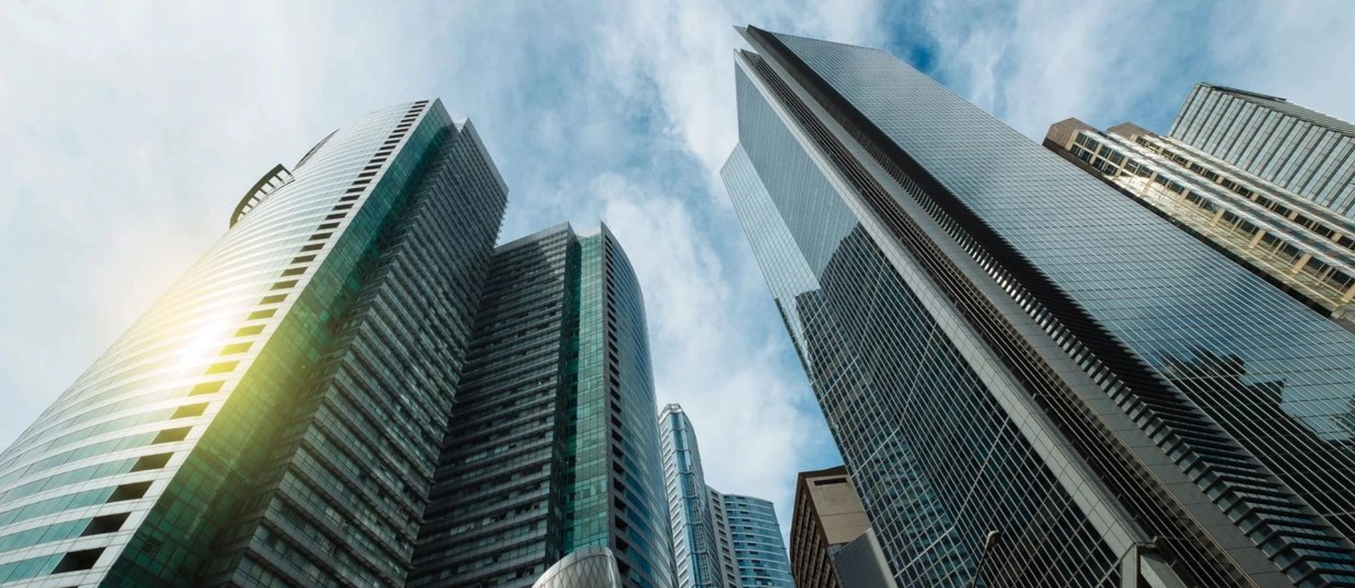 A view of some skyscrapers from below.