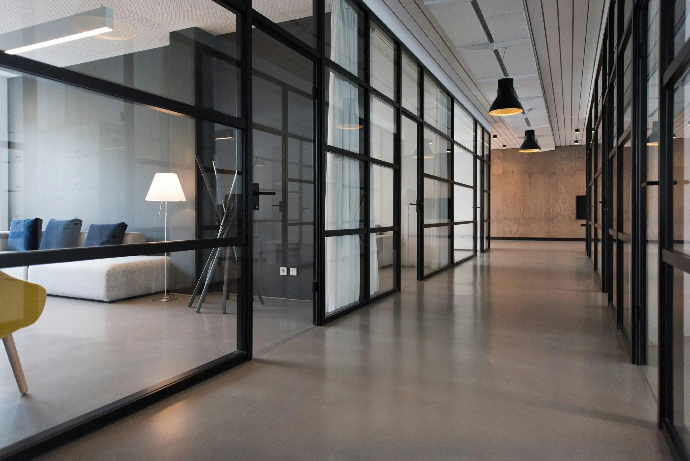 A room with glass walls and concrete floors.